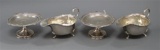 A pair of George V silver tazze with pierced gadroon and shell rims and a pair of silver sauceboats, 13.5 oz.